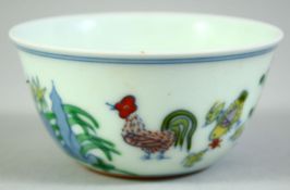 A CHINESE PORCELAIN CHICKEN CUP, the base with six character mark, 8cm diameter.