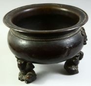 A VERY LARGE CHINESE BRONZE TRIPOD CENSER, the feet formed as crouching figures holding the censer