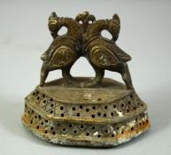 A 19TH CENTURY INDIAN BRASS FOOT SCRAPER, with finial formed as birds, 8.5cm wide.