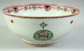A CHINESE FAMILLE ROSE PORCELAIN BOWL, decorated with roundels of floral motifs, 25.5cm diameter.