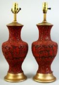 A PAIR OF CHINESE CINNABAR LACQUER LAMPS, the body of each with figures in a landscape with