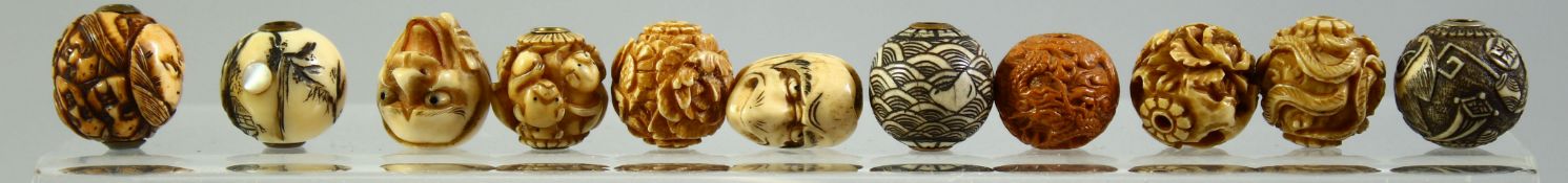 A GOOD COLLECTION OF ELEVEN MIXED CARVED IVORY OJIME BEADS, (11).