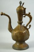 AN ISLAMIC ENGRAVED BRASS LIDDED EWER, 39cm high.