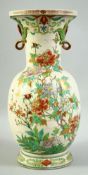 A JAPANESE TWIN HANDLE PORCELAIN VASE, painted with flowers and gilt highlights, 38.5cm high.