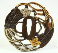 A JAPANESE BRONZE SHAKUDO TSUBA, of pierced design depicting an eagle and phoenix, signed, 8cm