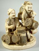 A JAPANESE MEIJI PERIOD CARVED IVORY OKIMONO of two basket sellers, the two figures completely