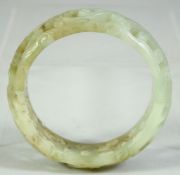 A CHINESE CARVED AND PIERCED JADE BRACELET, 8cm diameter.