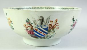 A CHINESE EXPORT ARMORIAL PORCELAIN BOWL, painted with a crest and flowers, 26.5cm diameter.