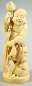 A CHINESE CARVED IVORY FIGURE of man holding a hammer aloft, signed to base, 18.5cm high.