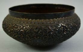 A SMALL INDIAN EMBOSSED SILVER BOWL, with floral decoration, 13.5cm diameter.