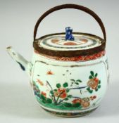 A CHINESE KANGXI PERIOD PORCELAIN TEAPOT AND COVER, painted with panels of native flora, the top