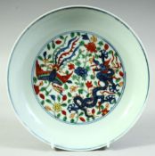 A CHINESE DOUCAI PORCELAIN DRAGON AND PHOENIX DISH, the base with six character mark, 20.5cm