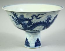 A CHINESE BLUE AND WHITE PORCELAIN STEM CUP, decorated with dragons, the interior with six character