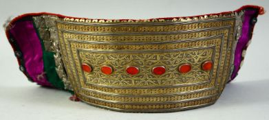 AN ISLAMIC TURKMAN CEREMONIAL METAL GARMENT, inset with carnelian stones, the metal plate mounted to