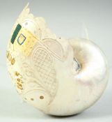 A DECORATED AND PIERCED NAUTILUS SHELL, 16cm long.