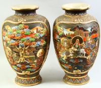 A LARGE PAIR OF JAPANESE SATSUMA VASES, with raised decoration depicting various figures and further