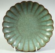 A CHINESE CELADON CRACKLE GLAZE LOBED DISH, 19cm diameter.