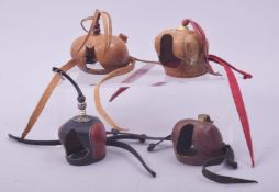 A COLLECTION OF FOUR ISLAMIC ARABIAN FALCON HOODS, various sizes.