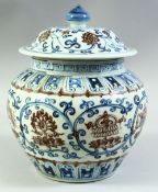 A CHINESE BLUE AND UNDERGLAZE RED PORCELAIN JAR AND COVER, decorated with lotus and eight treasure