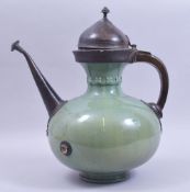 A VERY UNUSUAL 17TH/18TH CENTURY SAFAVID GREEN GLAZED POTTERY EWER with metal mounts, the pottery
