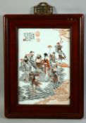 A CHINESE CORAL RED AND WHITE PORCELAIN PANEL in a hardwood frame, the panel painted with a