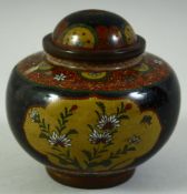 A JAPANESE CLOISONNE LIDDED KORO, decorated with panels of butterflies and flora, 11cm high.