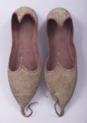 A PAIR OF 19TH CENTURY OTTOMAN METAL THREAD LEATHER EMBROIDERED SHOES, 26cm long.