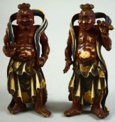 AN UNUSUAL PAIR OF JAPANESE MEIJI PERIOD STAINED IVORY FIGURES of buddhistic temple guardians,