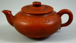 A CHINESE YIXING TEAPOT AND COVER, with bands of raised floral decoration, 15cm wide (handle to