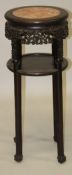 A CHINESE MARBLE INSET CARVED HARDWOOD TWO TIER STAND, with carved foliate frieze and hardwood