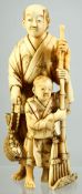 A JAPANESE CARVED IVORY OKIMONO of farmer and his child, 10.5cm high.