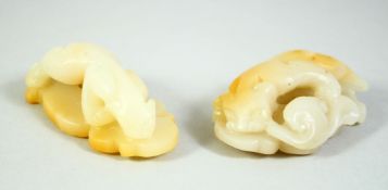 A GOOD PAIR OF CHINESE WHITE JADE CHILONG & PHOENIX CARVINGS, the stone with pale russet inclusions,