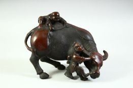 A CHINESE BRONZE MODEL OF AN OXEN, with two young boys upon it, 16.5cm long.