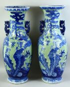 A LARGE PAIR OF CHINESE CELADON BLUE AND WHITE PORCELAIN VASES, with raised decoration depicting