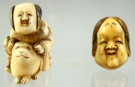 A JAPANESE CARVED IVORY NETSUKE of a seated boy playing with a rabbit, together with a miniature noh