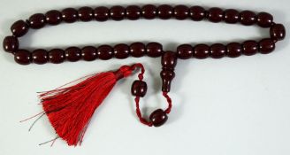 A SET OF CHERRY AMBER / BAKELITE PRAYER BEADS, comprising 36 beads (including toggle) and two