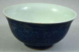 A CHINESE BLUE GLAZE PORCELAIN BOWL, decorated with curling foliate design, the base with six