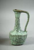 A SMALL CHINESE CELADON CRACKLE GLAZE OIL VESSEL, 12.5cm high.