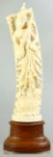 A GOOD INDIAN CARVED IVORY FIGURE mounted on a wooden stand, possibly depicting the goddess Lakshmi,