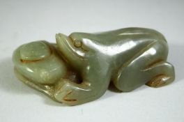 A CHINESE JADE CARVING OF A FROG, 8.5cm long.
