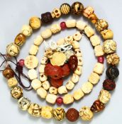 A GOOD JAPANESE CARVED IVORY OJIME BEAD NECKLACE, with various carvings / subjects; three signed,
