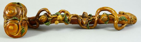 A CHINESE GLAZED POTTERY RUYI SCEPTER of naturalistic form, 33cm long.