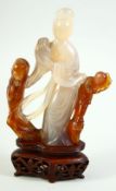 A CHINESE CARVED AGATE FIGURE OF GUANYIN, on a fitted carved hardwood stand, 18.5cm on stand.