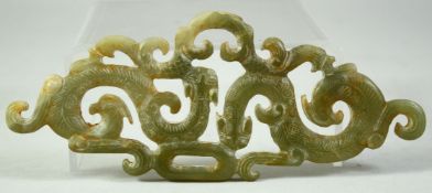 A LARGE CHINESE CARVED AND PIERCED JADE AMULET, with chilong motifs, 15cm long.