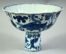 A CHINESE BLUE AND WHITE PORCELAIN STEM CUP, decorated with fish and algae, the interior with six