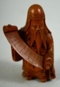 A SMALL JAPANESE CARVED WOOD FIGURE of a sage holding a scroll, 6cm high.