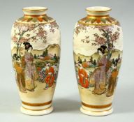 A PAIR OF JAPANESE SATSUMA VASES, painted with female figures in a landscape and further embellished