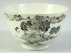 A CHINESE BLACK AND WHITE PORCELAIN BOWL, the exterior painted with a landscape scene, the base