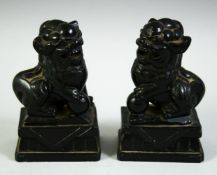 A PAIR OF 19TH CENTURY CHINESE CRAVED BLACK HARDSTONE FO DOGS, 10cm high.