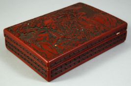 A CHINESE CINNABAR LACQUER RECTANGULAR LIDDED BOX, the lid depicting a river landscape with